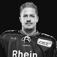 Een man in een zwart ijshockeyshirt met het owayo-logo op de borst en de tekst 'Rhein' op de voorkant.